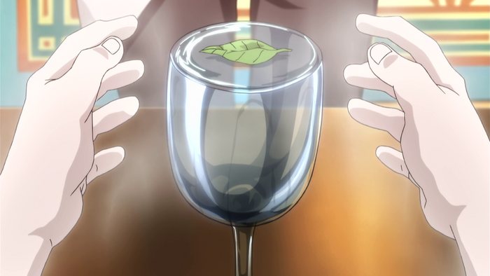 The Water Divination — a glass of water with a leaf floating on the surface, held between two hands